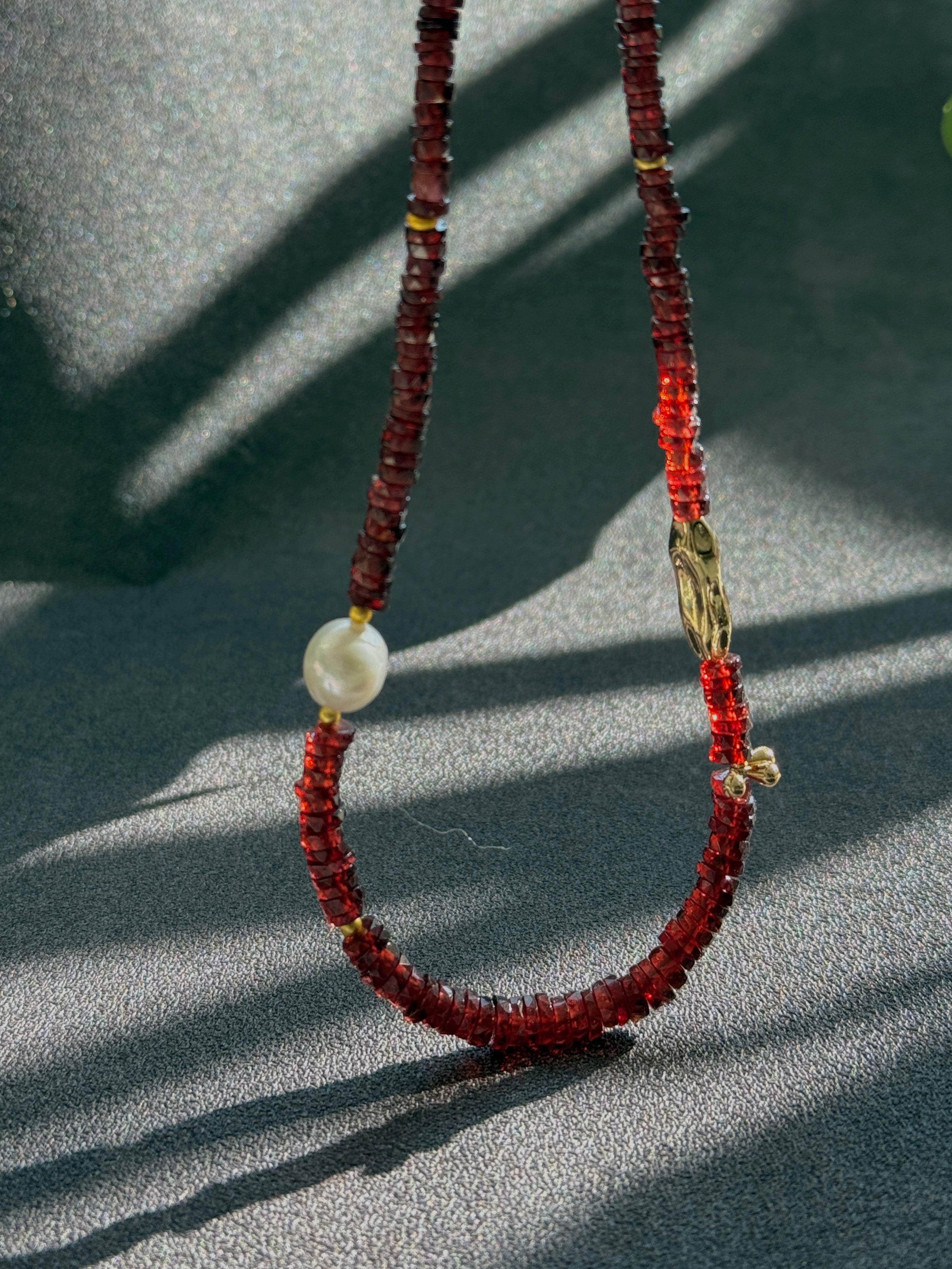 Quiet Flame · Minimalist necklace featuring natural garnet beads