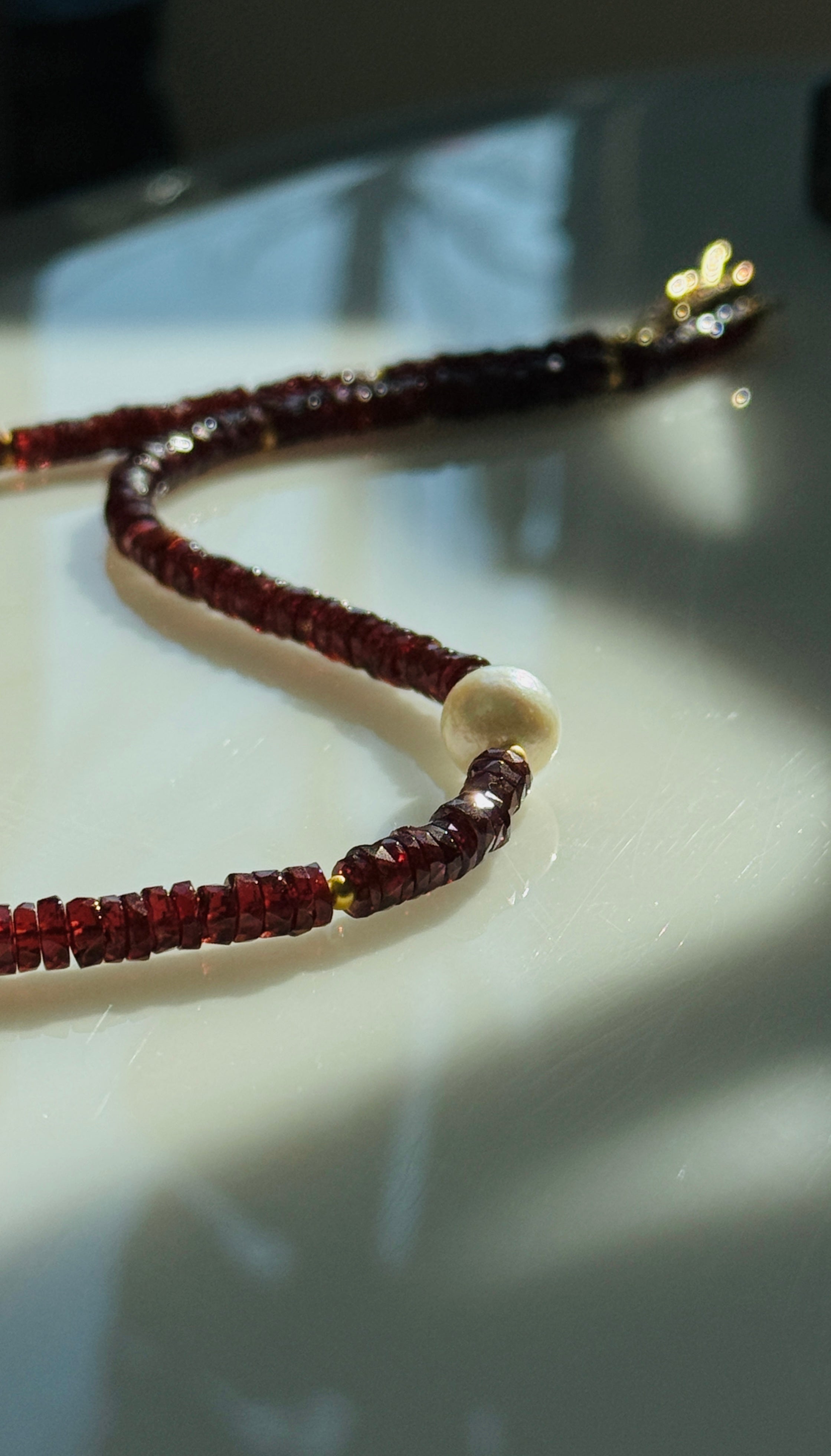 Quiet Flame · Minimalist necklace featuring natural garnet beads