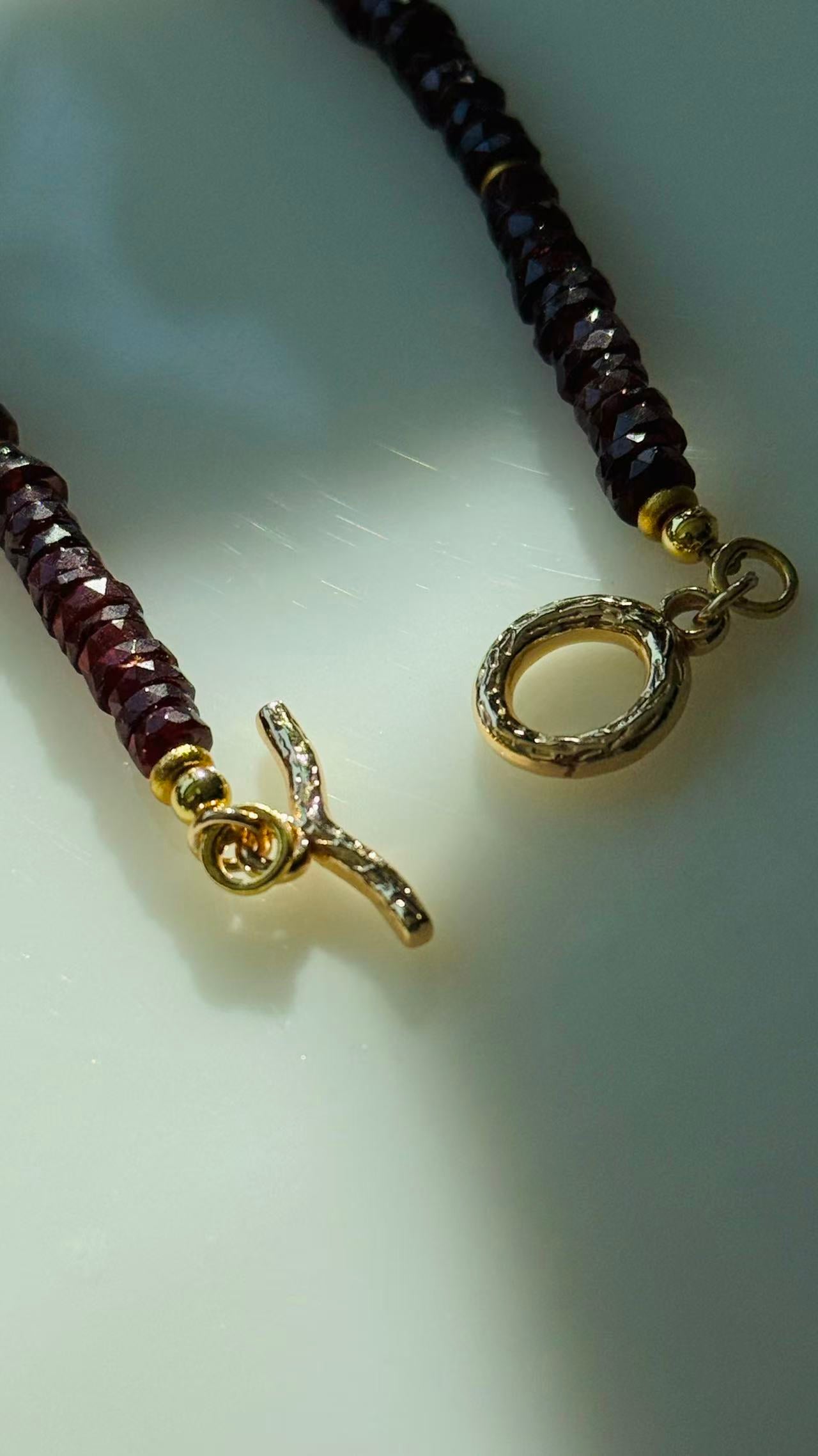 Quiet Flame · Minimalist necklace featuring natural garnet beads
